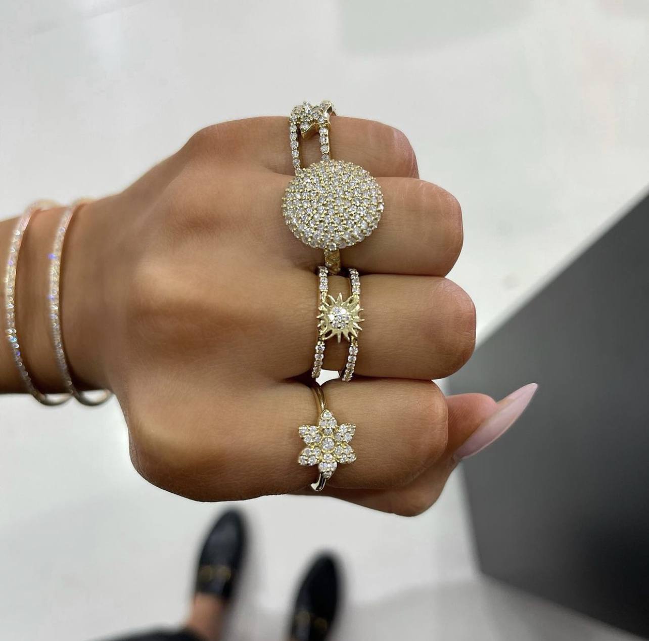 gold stackable rings on multiple fingers