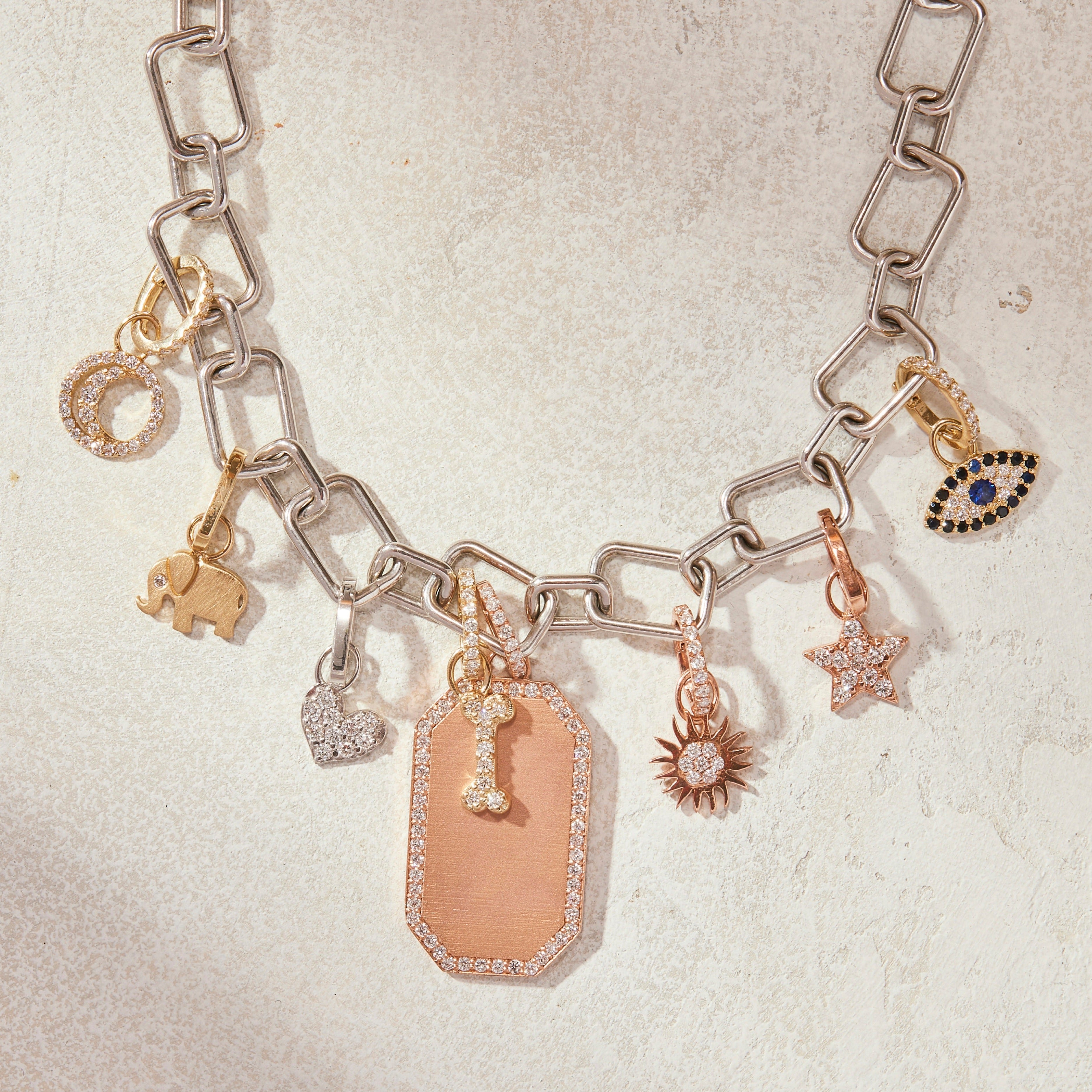 An enamel, sapphire and diamond charm bracelet , 1930 | Symbolic & Chase